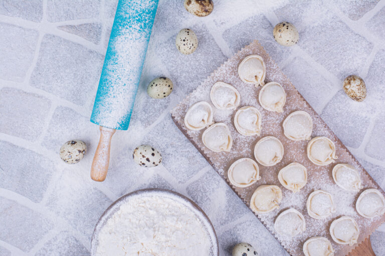 Uncooked khinkali stuffings on flour on the ground. High quality photo