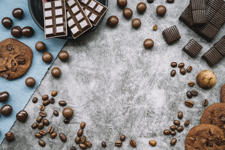 overhead-view-chocolate-products-with-roasted-coffee-beans-grunge-backdrop